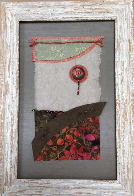 A small banner made from material, quitled, appliqued, and framed